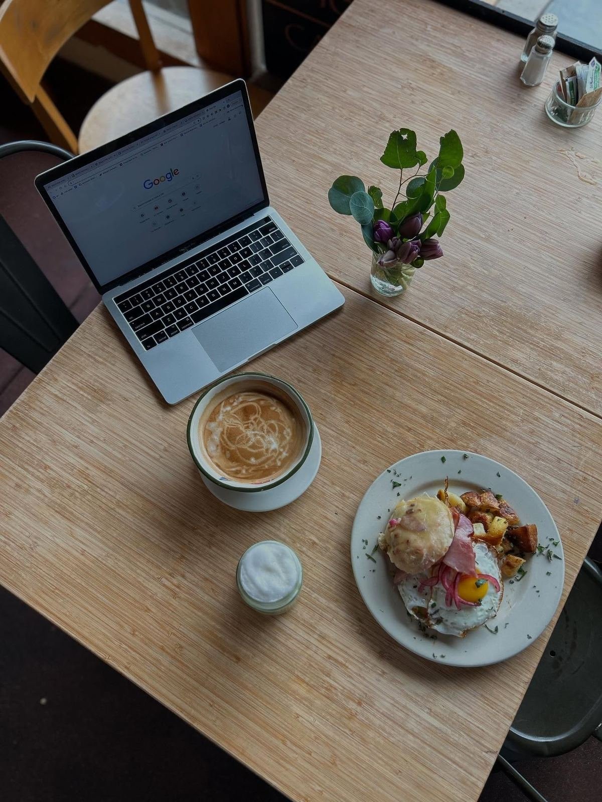A Wild Plum table — latte, brunch, and fresh flowers
